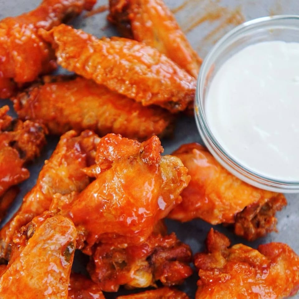 Close-up of buffalo wings with a side of ranch dressing, from Brynn Bradley.